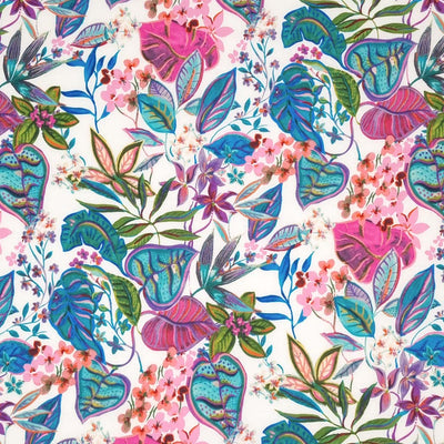 Leaves and flowers in pinks and blues are printed on an ivory pima cotton lawn fabric