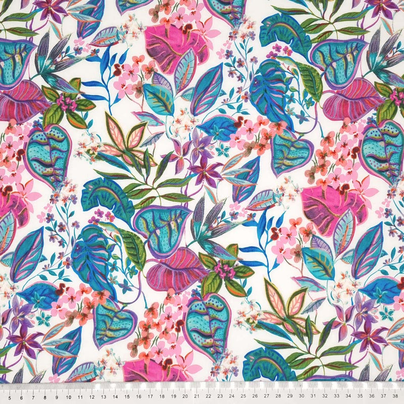 Leaves and flowers in pinks and blues are printed on an ivory pima cotton lawn fabric with a cm ruler