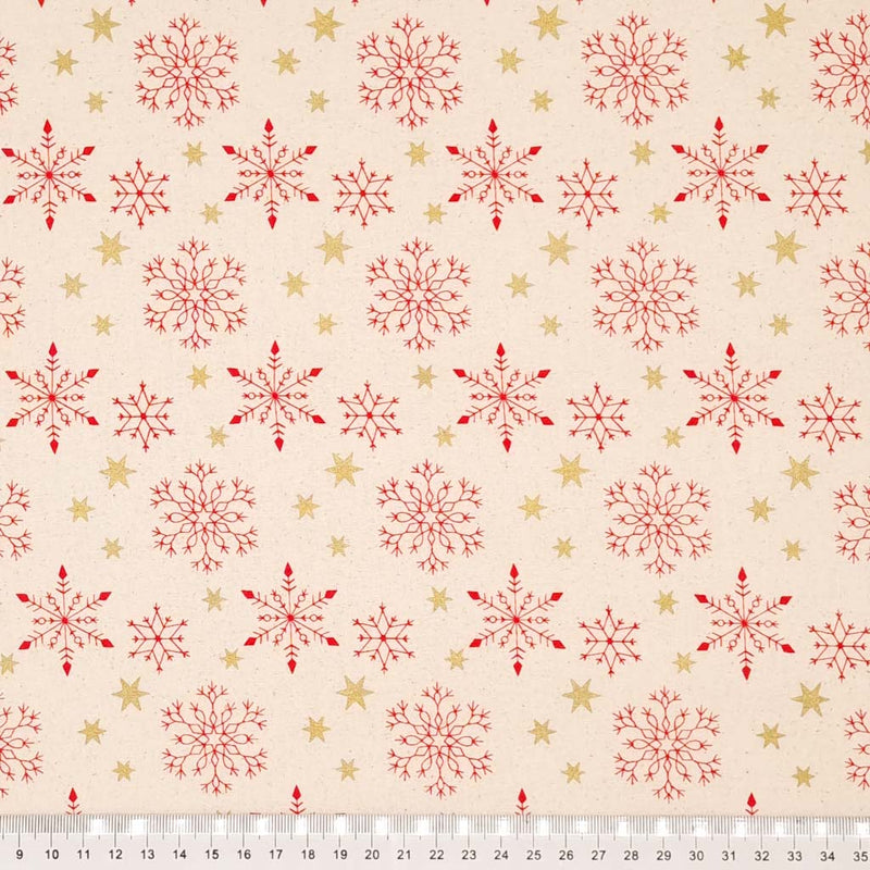 Red scandi snowflakes and gold metallic stars printed on a natural 100% cotton fabric. with a cm ruler
