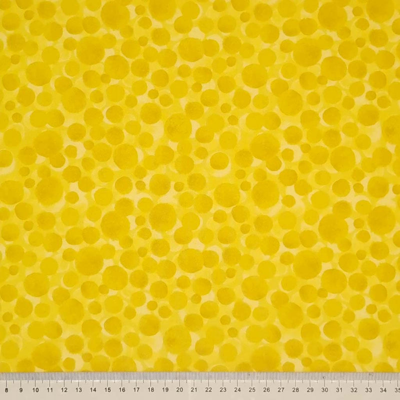 Multi-sized dots printed on a sunshine yellow 100% cotton with a cm ruler