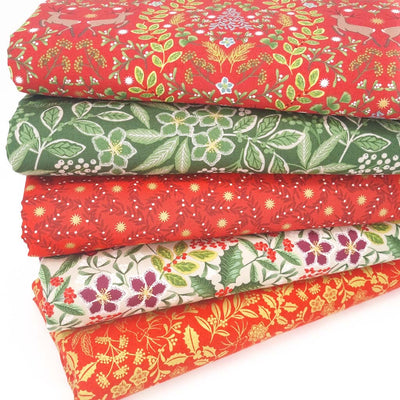 A christmas fat quarter bundle with reindeer and florals in a red and green colourway by Lewis & Irene