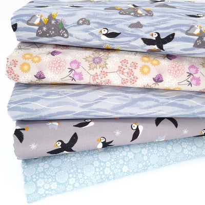 A fat quarter bundle with puffins in greys and lilacs