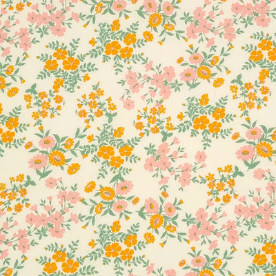 Calendula flowers are printed on this cream polycotton fabric.