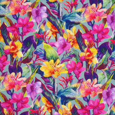 Vibrant coloured flowers are printed on a mint linen fabric