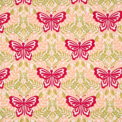 Large magenta butterflies printed on a peach and green polycotton fabric