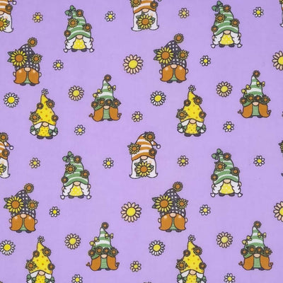 Cute little gonks with daisies are printed on a lavender coloured polycotton fabric