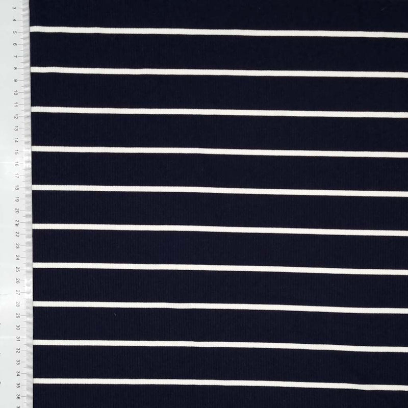 A ribbed navy jersey fabric with a thin white stripe with a cm ruler