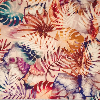 Multicoloured leaves are printed on a viscose dressmaking fabric