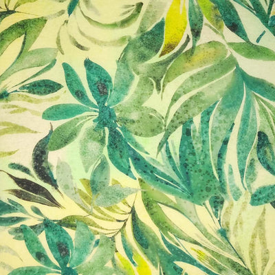 Watercolour green leaves are printed on a viscose fabric