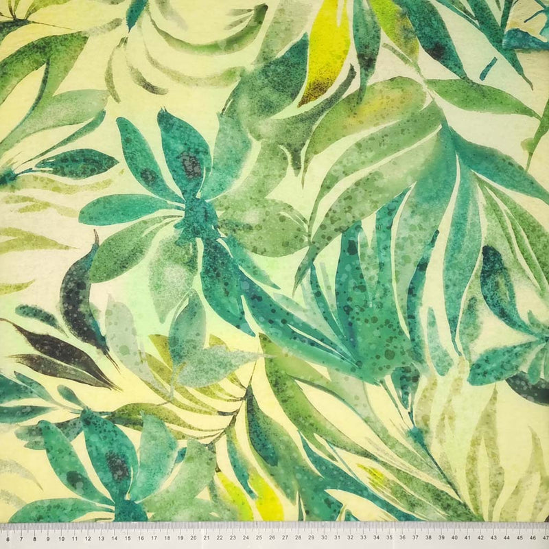 Watercolour green leaves are printed on a viscose fabric with a cm ruler
