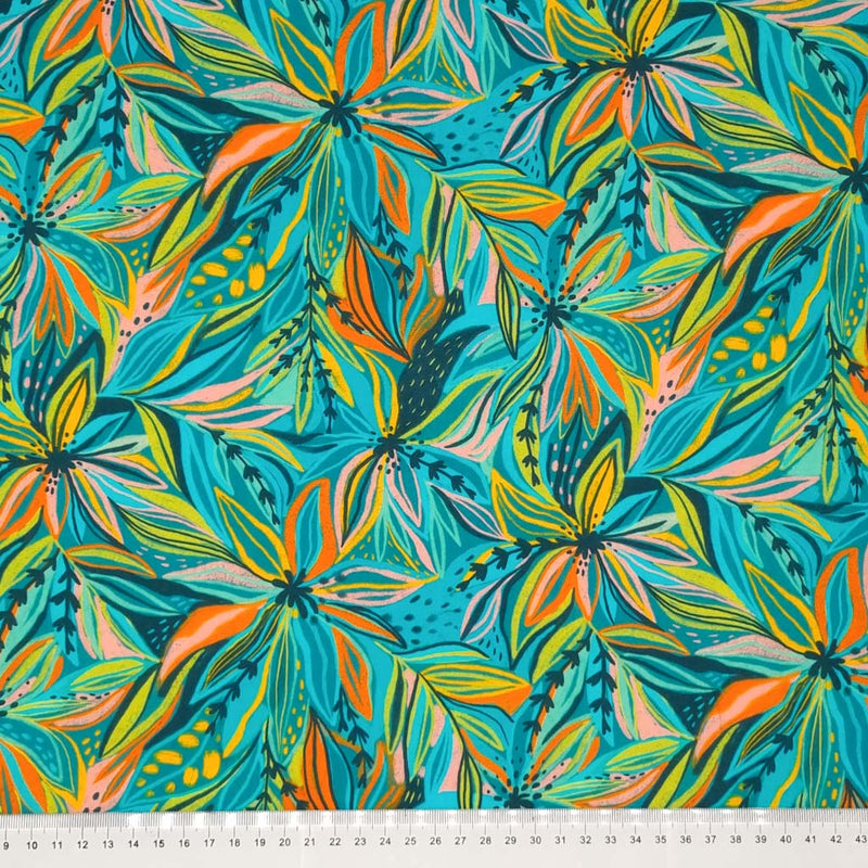 Tropical florals in orange and turquoise printed on a viscose fabric with a cm ruler