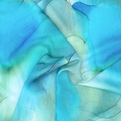 Flowing ink viscose fabric in blue and green with a swirl