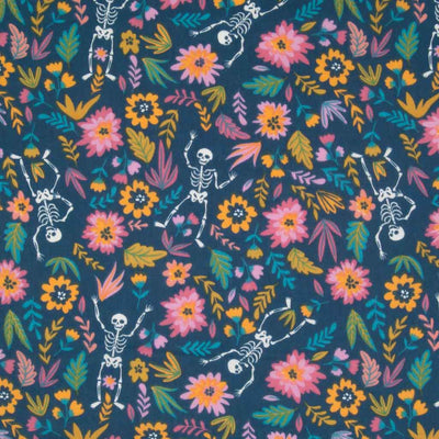 Skeletons dance on a bed of brightly coloured flowers, printed on a blue halloween polycotton fabric