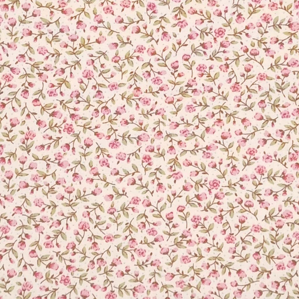 A ditsy pink floral pattern is printed on a cream Rose & Hubble cotton poplin fabric