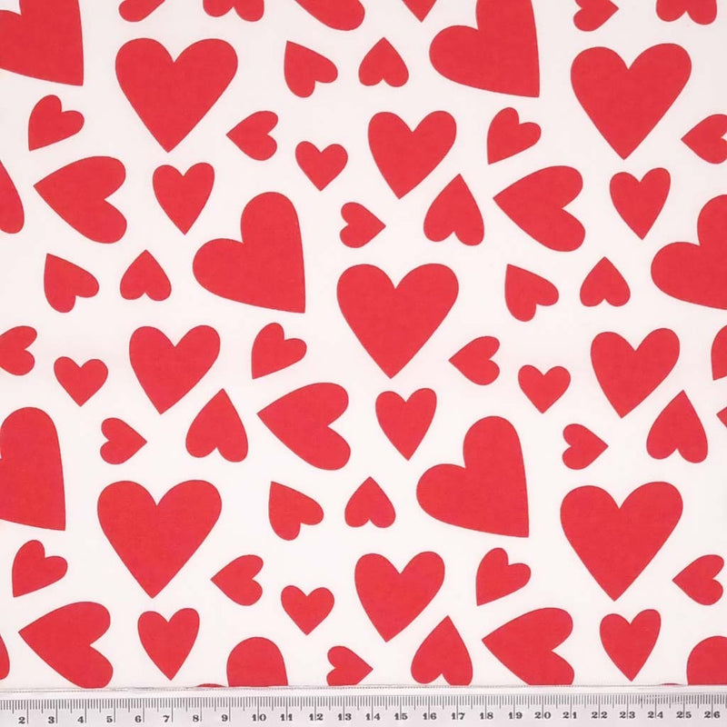 Multi hearts by Rose & Hubble features multi sized white hearts on a white 100% cotton poplin fabric. with a cm ruler
