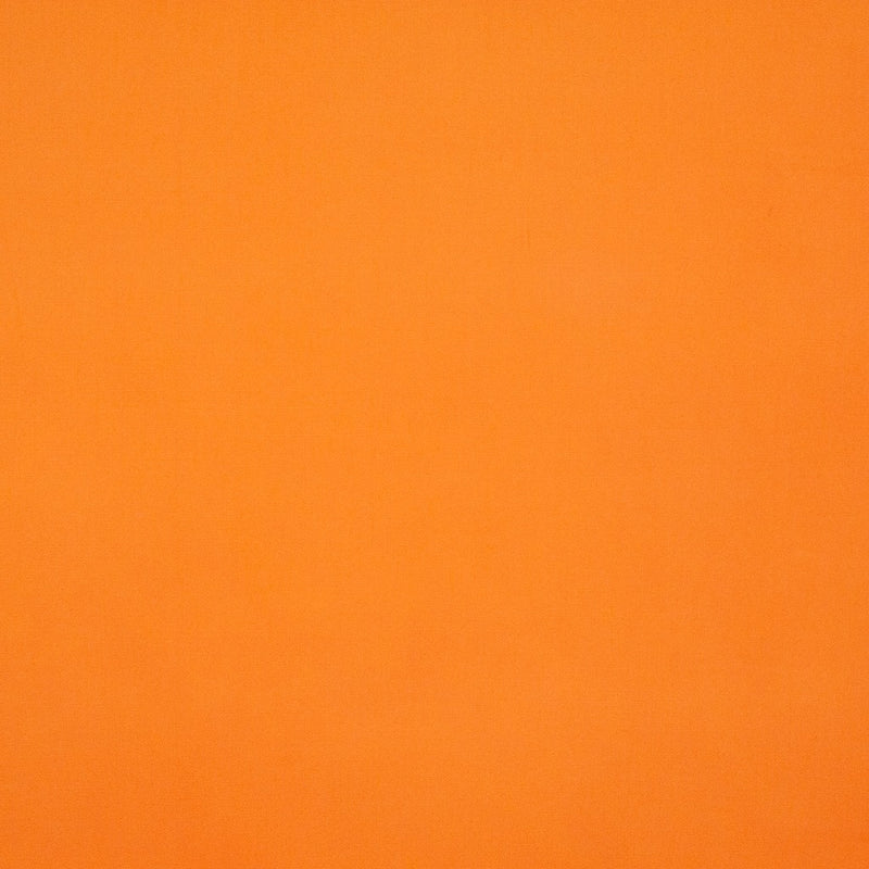 A plain tangerine orange coloured polycotton