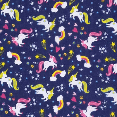 Unicorns, rainbows and stars are printed on a navy polycotton fabric