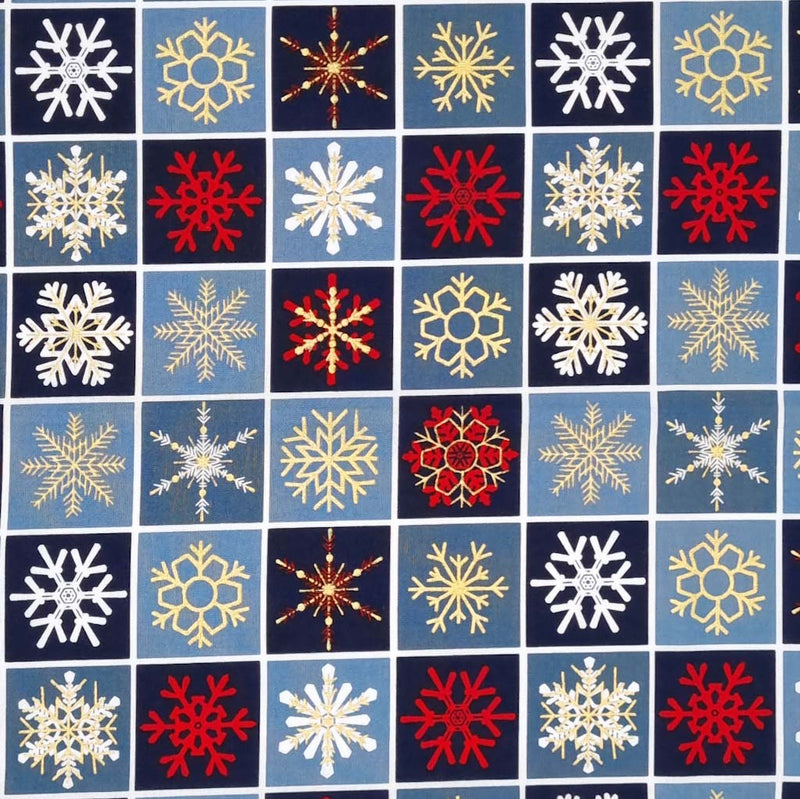 Printed gold, red and white metallic snowflakes are printed on this navy checkboard style 100% cotton fabric. 