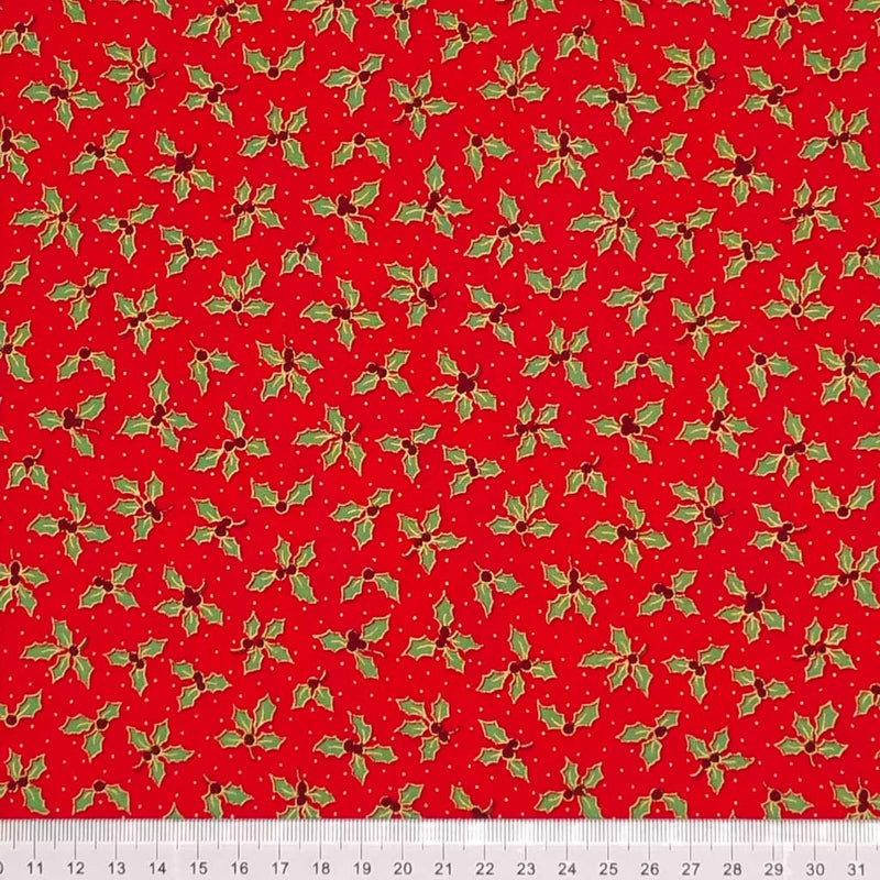 Small holly leaves with red berries are printed on a red 100% cotton fabric with a cm ruler