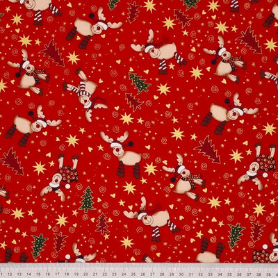 Cute , smiling reindeer wearing colourful scarves and santa hats and metallic stars and hearts are printed on this red, cotton fabric by Rose & Hubble with a cm ruler