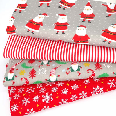 A christmas fat quarter bundle of 4 christmas designs including festive santas and gonks in red and silver colourway.