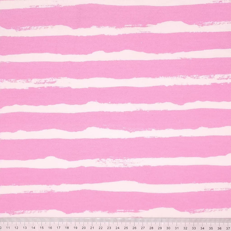White painted stripes printed on a pink french terry fabric with a cm ruler at the bottom