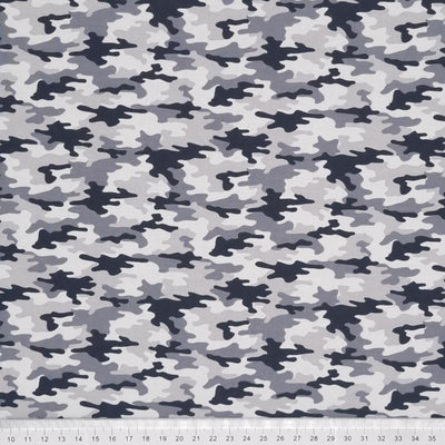 A greyscale camo printed on a cotton jersey fabric with a cm ruler at the bottom