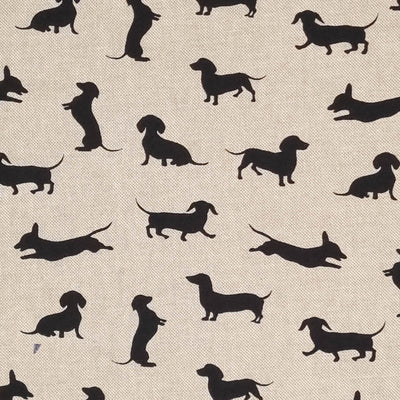 Black silhouettes of dachshund dogs are printed on a craft canvas fabric