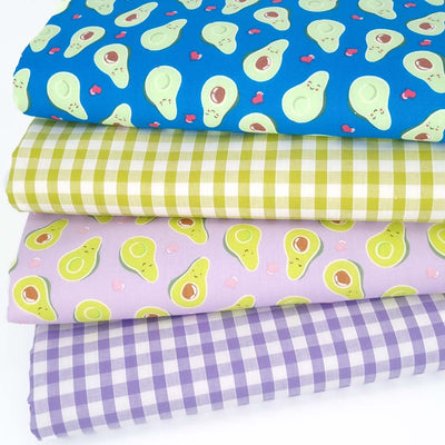 A bundle of 4 polycotton fat quarters with avocados and ginghams in lilac and green