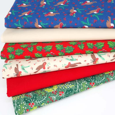 A christmas fat quarter bundle of 6 festive designs including robins and holly in blue, green, red and beige colourways.