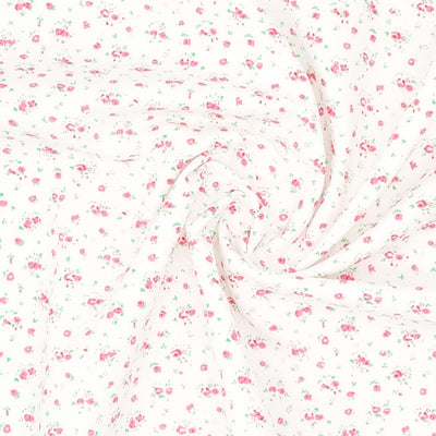 A ditsy pink rose bud fabric print on polycotton