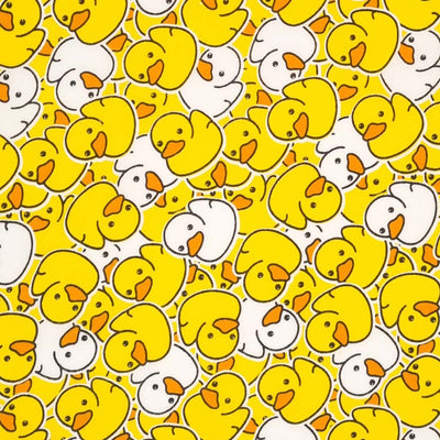 Yellow and white scattered rubber ducks are printed on a white polycotton fabric. 