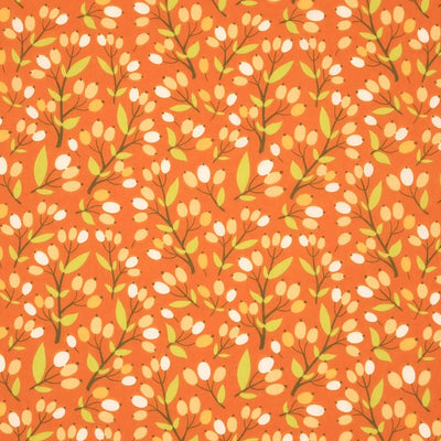 A floral design with berries printed on a rust coloured polycotton fabric