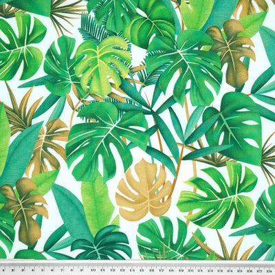 Tropical green leaves printed on a white cotton poplin by Rose & Hubble with a cm ruler