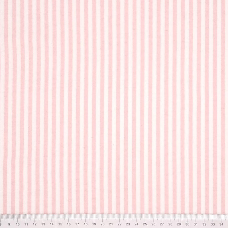 Pink and white candy stripes printed on a soft brushed polycotton winceyette with a cm ruler at the bottom