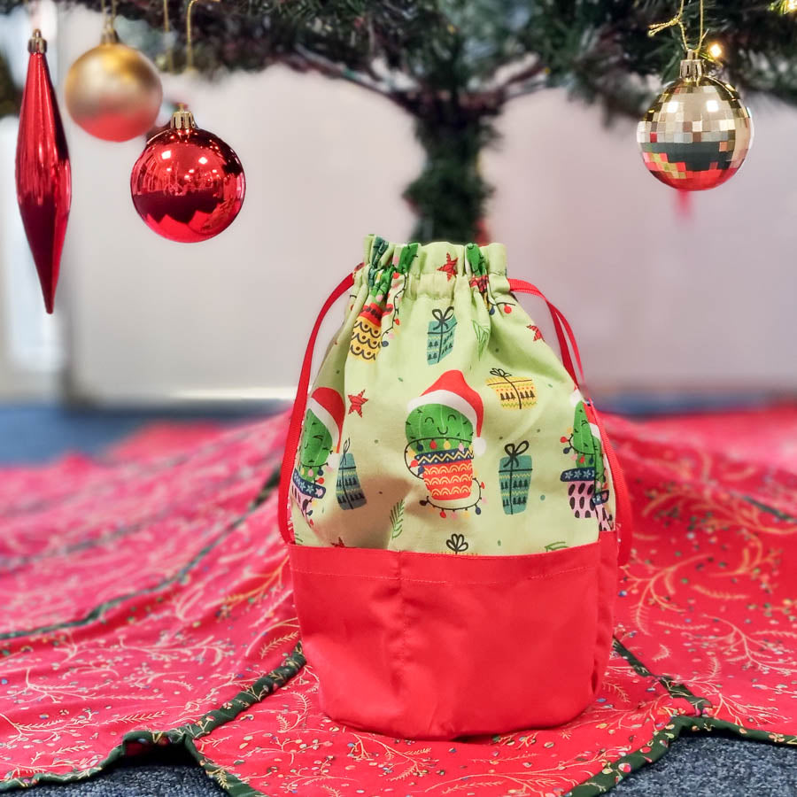 A christmas gift bag made with fabric cacti