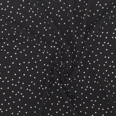 Small scattered white spots printed on black viscose fabric