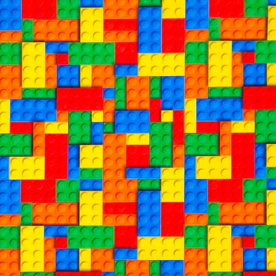 Pattern of colourful building blocks in red, orange, yellow, green, blue, and purple printed on a cotton fabric.