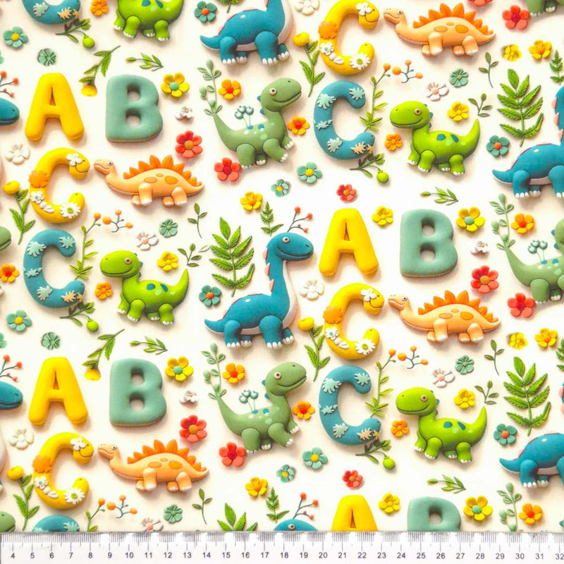 3D dinosaurs and letters printed on a white cotton fabric by Little Johnny with a cm ruler