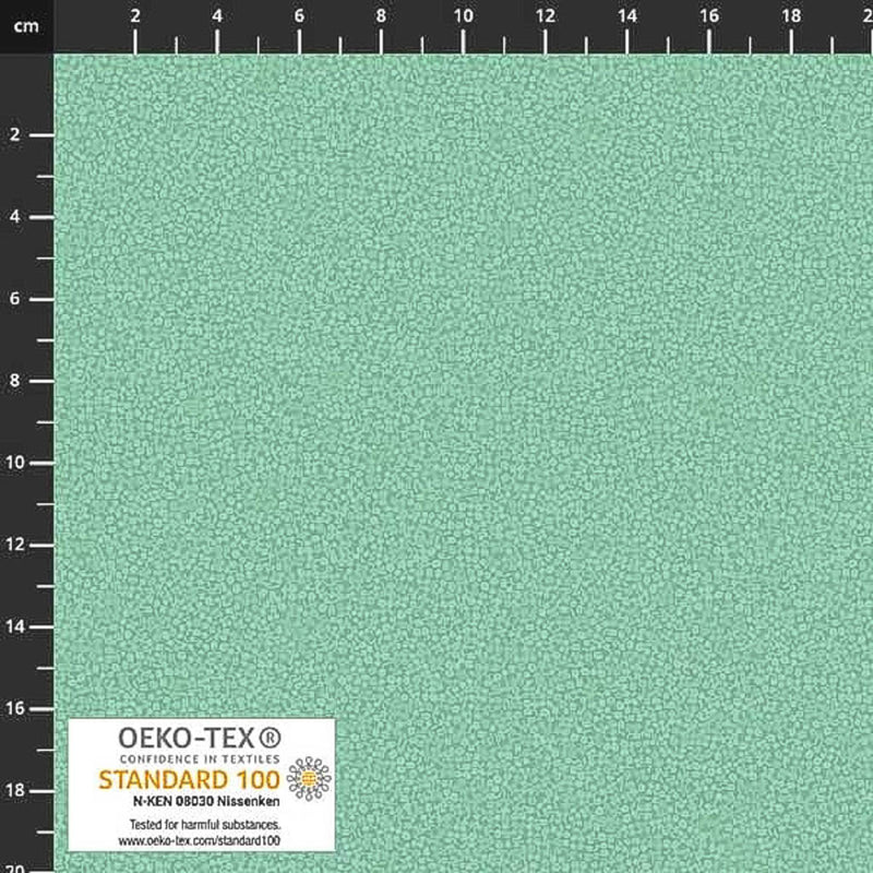 Stof Brighton cotton blender quilting fabric in mist green with a ruler