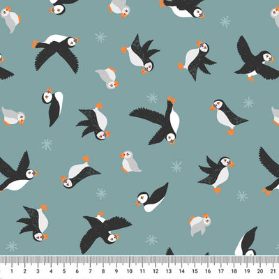 Puffins in flight printed on a blue/grey cotton quilting fabric
