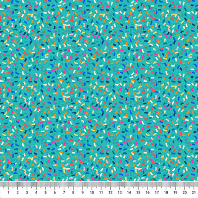 Colourful carnival confetti is printed on a turquoise quilting fabric by Lewis & Irene with a cm ruler