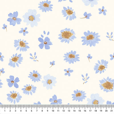 Hand-printed cornflower blue flowers on a quilting fabric with a cm ruler