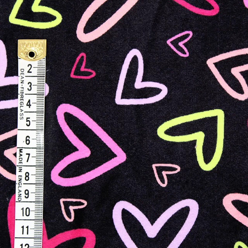 Black fleece with colourful hearts back with a white sherpa fleece with a cm ruler