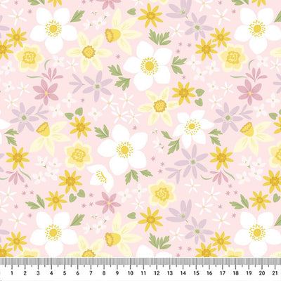 Daffodils printed on a pale pink cotton fabric by Lewis & Irene with a cm ruler