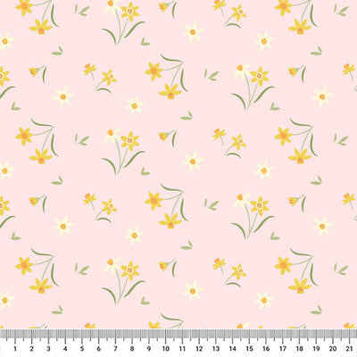 Sunshine yellow daffodils on a pretty pastel pink background printed on cotton fabric with a cm ruler