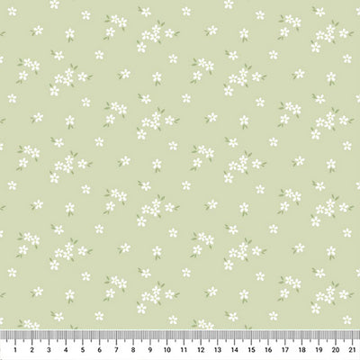 A delicate print of white daisies bunched on a gorgeous light sage cotton fabric with a cm ruler