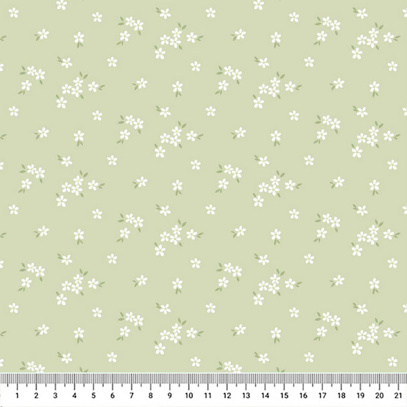 A delicate print of white daisies bunched on a gorgeous light sage cotton fabric with a cm ruler