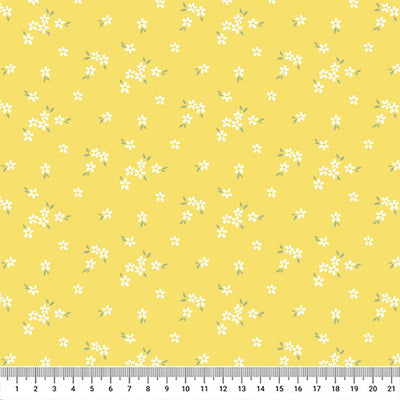 A delicate print of white daisies bunched on a gorgeous, bright yellow cotton fabric with a cm ruler