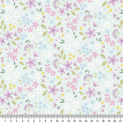 Pressed flowers printed on a light teal cotton quilting fabric with a cm ruler